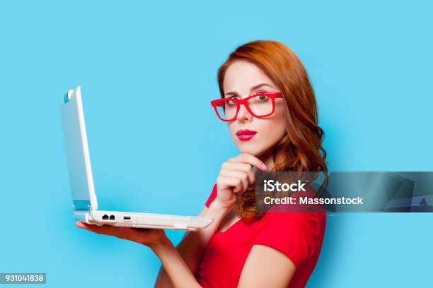 Young Beautfiul Redhead Girl In Eyeglasses With Laptop Computer Stock Photo - Download Image Now