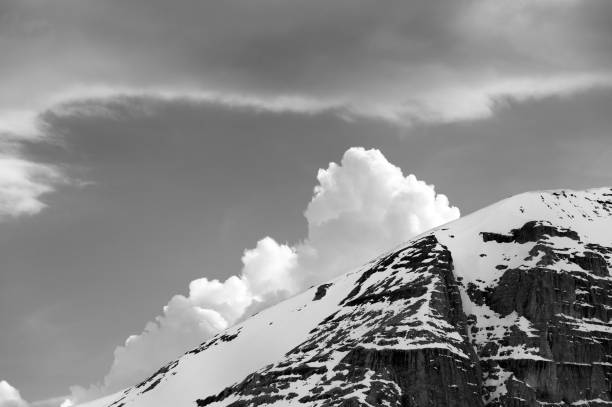 istock Black and white snowy rocks and clouds 931046338