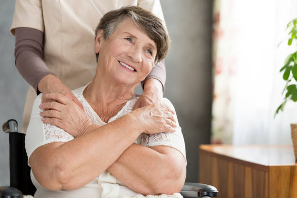 istock Happy grandmother supported by nurse 931046344