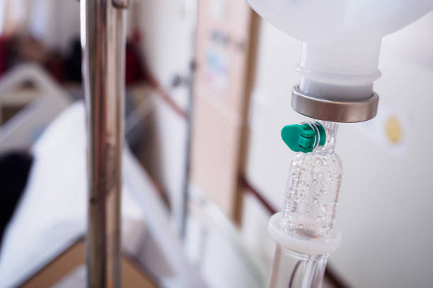 istock Medical drip with hospital blurred background 931050526