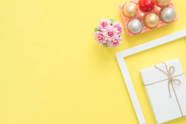 istock Flat lay top view colorful easter egg painted in pastel colors composition and spring flowers on yellow pastel color background. Easter day background top view with copy space. 931053114