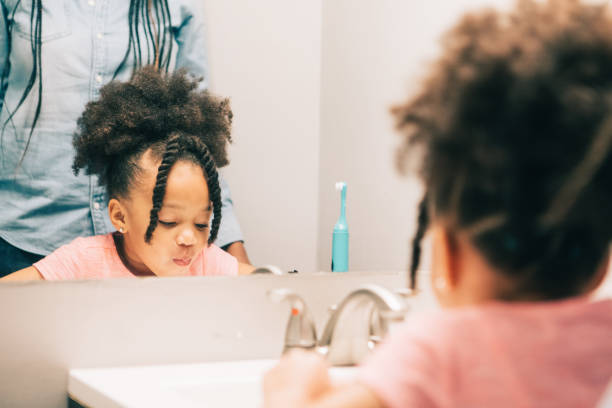 istock little girl brushing her teeth 931053922