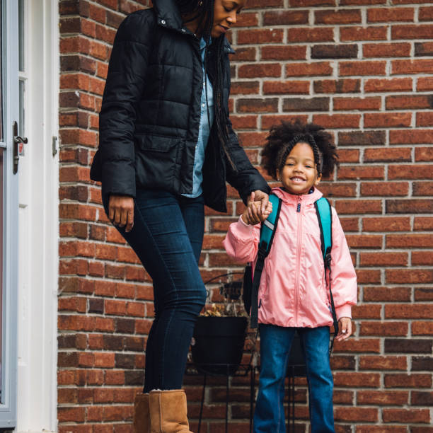 istock young girl going to school with parent 931055534