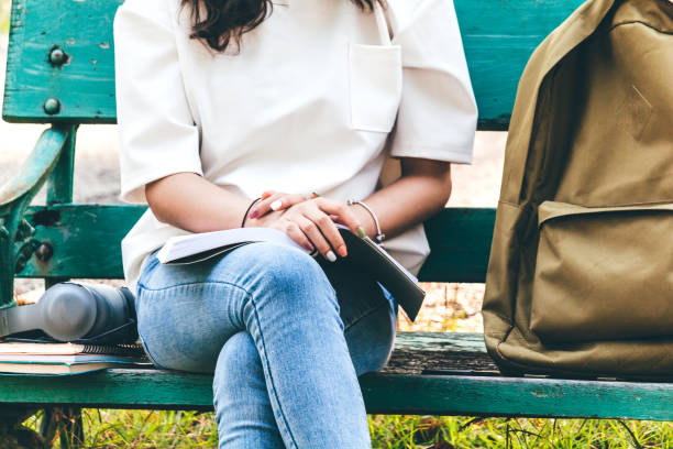 istock Woman students reading notebooks outdoors.Education concept 931055634