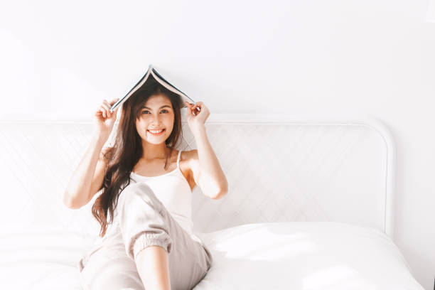 istock Woman with book on bed in the morning 931055662