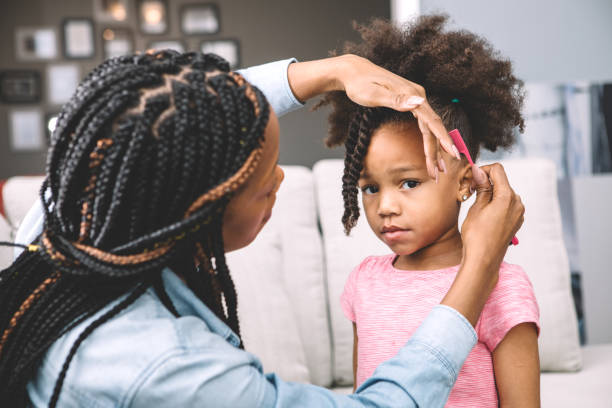 istock mother styling daugher's hair 931055838