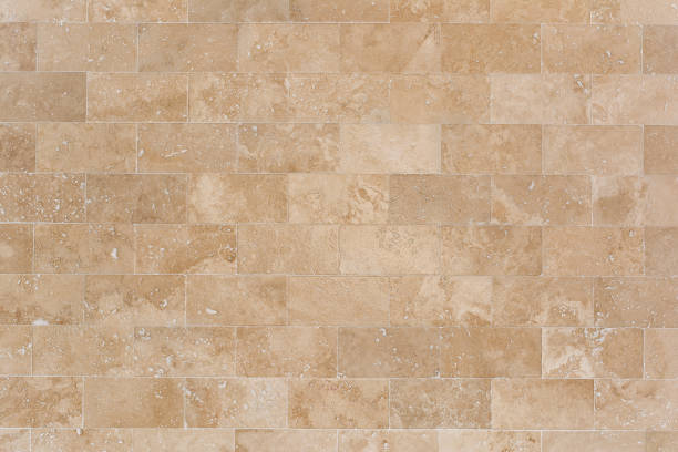 Stone facing of beige wall made of travertine. Texture of masonry. Stone facing of beige wall made of travertine. Texture of masonry. travertine pool photos stock pictures, royalty-free photos & images
