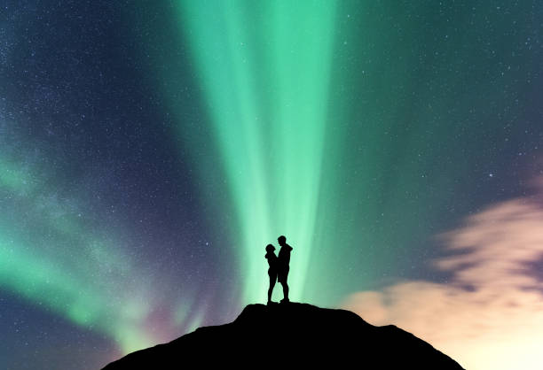 istock Aurora and hugging couple on the mountain peak 931058556