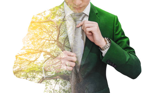 Double exposure businessman in green suit with big tree and sunlight