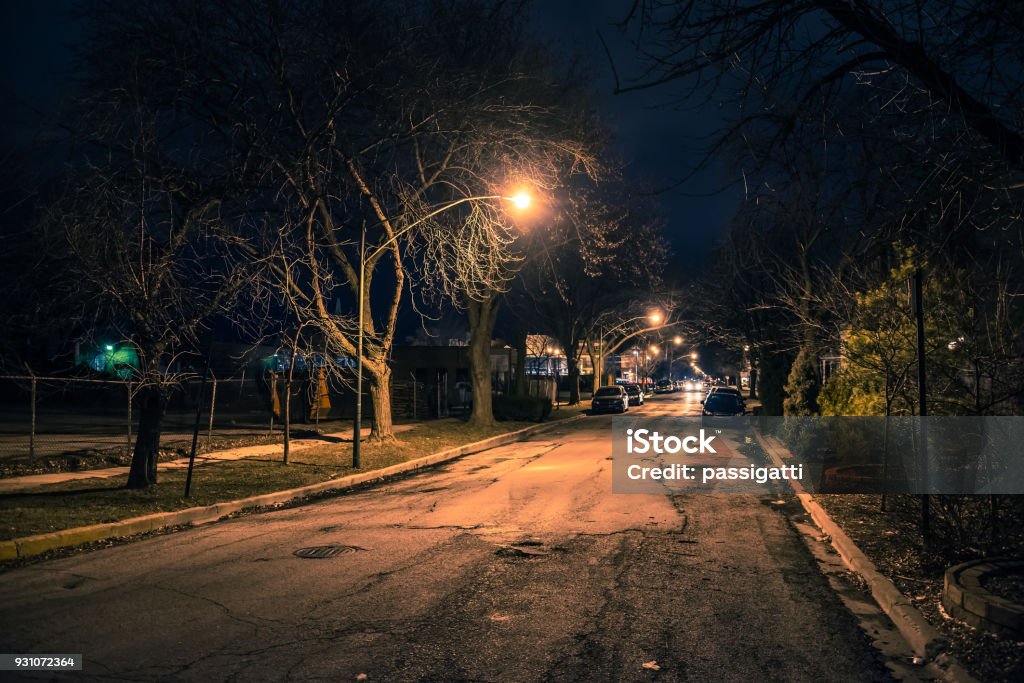 Dark and eerie urban city street at night Night Stock Photo