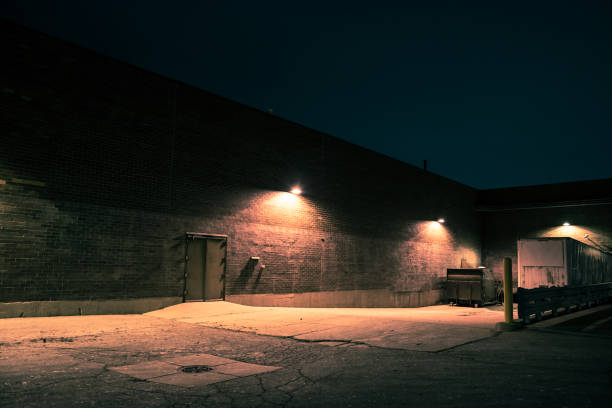 istock Urban warehouse building and loading dock with a semi trailer at night 931072446