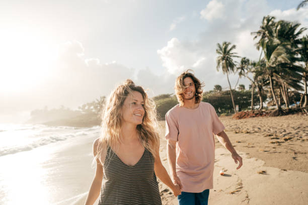 istock Happy Couple walking on the beach 931075272