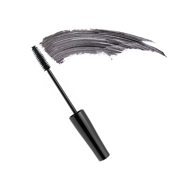 Black mascara brush stroke with applicator brush stock photo