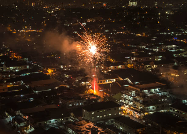 istock Sparkling firework bursting above Asian neighbourhood 931082336