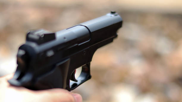 istock Close-up image of gun on the blur background. 931082632