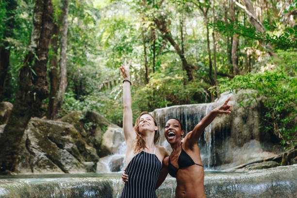 istock Women couple enjoying the waterfall 931083126