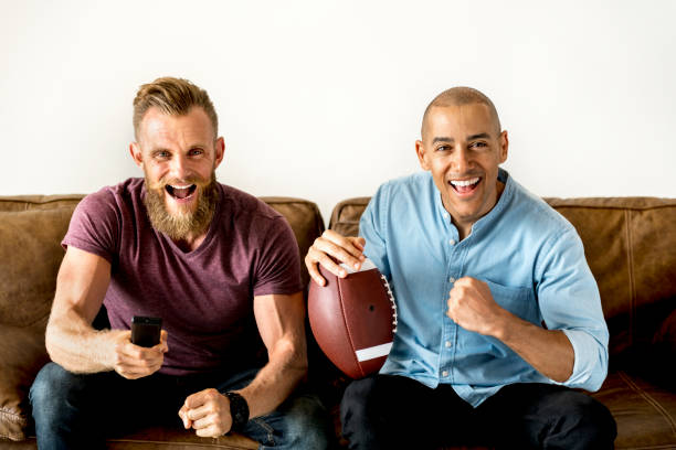 istock Man sitting together on a couch watching sport 931088136