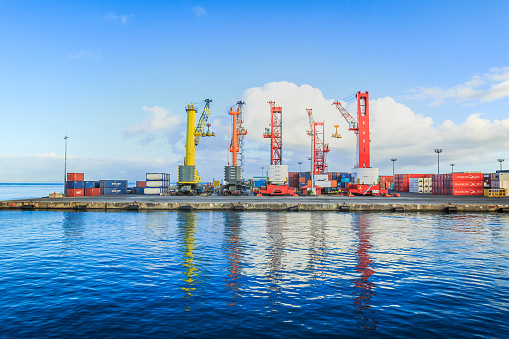 Papeete, French Polynesia – March 16, 2018 :  The big cranes and Containers at Large commercial port  in Tahiti PAPEETE, FRENCH POLYNESIA.
