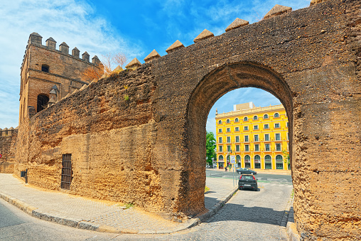 Seville, Spain- June 08, 2017 : Wall of Seville (Muralla almohade de Sevilla) are a series of defensive walls surrounding the Old Town of Seville. The city has been surrounded by walls since the Roman period.