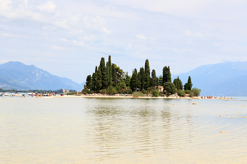 Island Isola di San Biagio at Lake Garda with mountain panorama, Italy