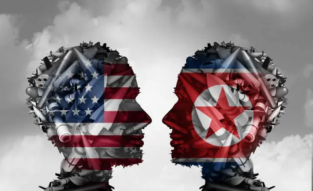 North Korea and United States talks facing nuclear tensions as a meeting with two groups of bombs and missiles shaped as a human head as a 3D illustration.