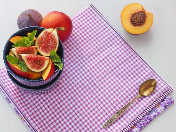 Purple background. Healthy eating concept. Fruit salad with fresh fruits. stock photo
