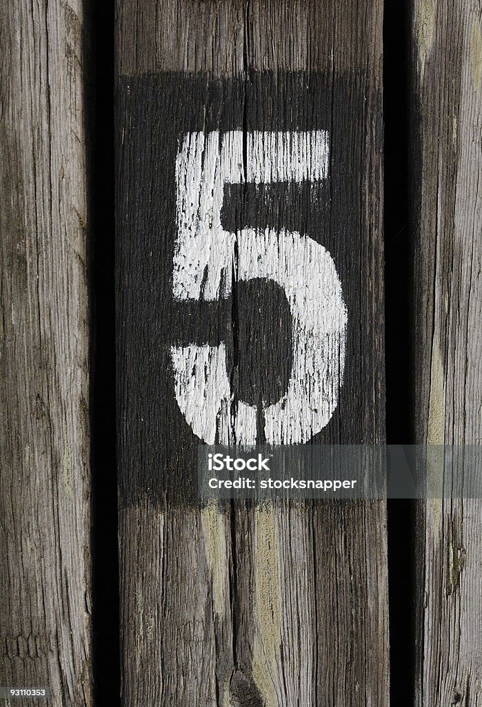 The number five on a wooden post Number five painted on wood Color Image Stock Photo