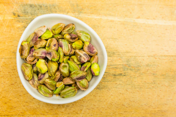 istock Bowl with shelled, roasted pistachios. View from above. 931105770