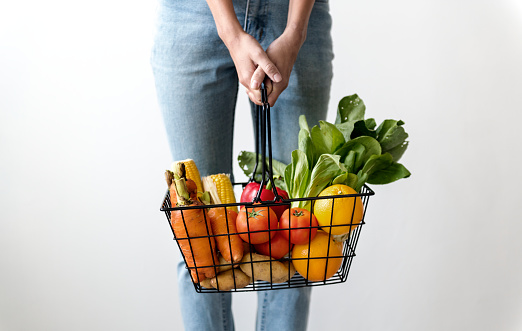 Woman holding a basket of vegetables