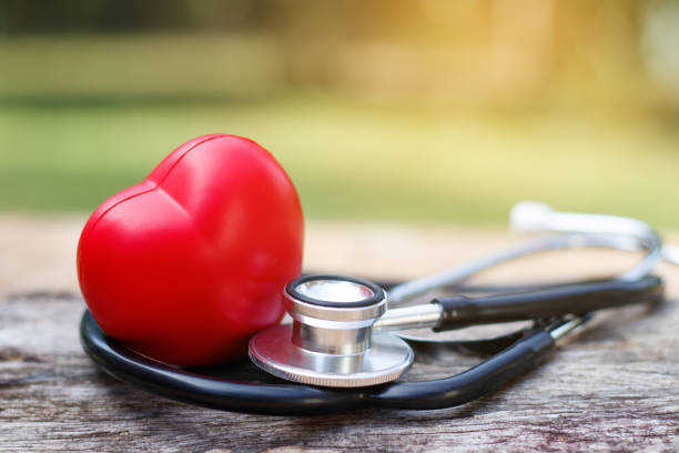 istock Red heart and a stethoscope on wooden background. 931117862