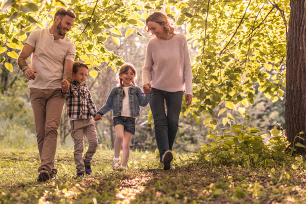 istock Young happy family holding hands and taking a walk in springtime. 931118438