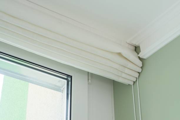 istock Roman curtains in the interior. From natural light linen, with decorative braid. 931118888