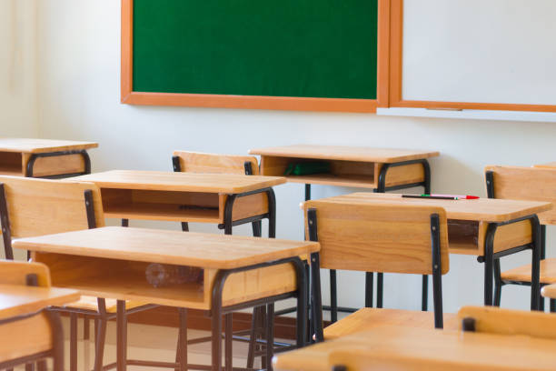 istock Chair in empty classroom, lecture armchairs in school, or college 931118982