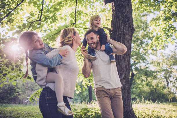 istock Happy parents talking while having fun with their kids in springtime. 931121480