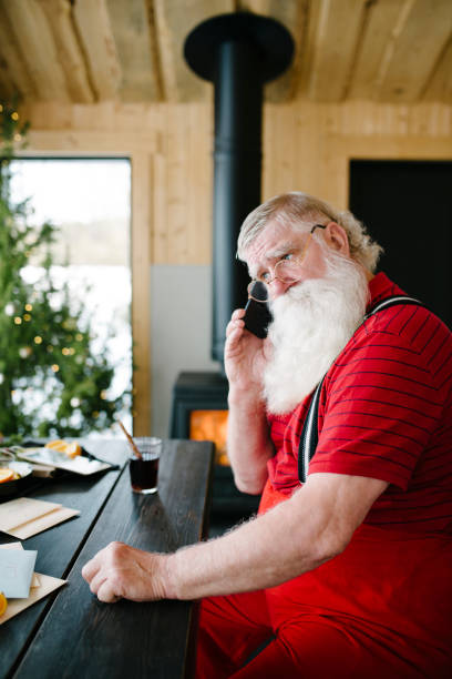 istock Santa Claus talking with phone 931125472