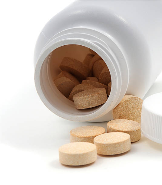 istock Pills spilling out of a jar 2 93112648