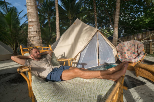 istock Luxury camping young man relaxing at sunset 931126796