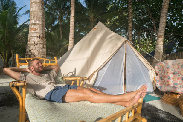 istock Young man relaxing in luxury campsite 931126864