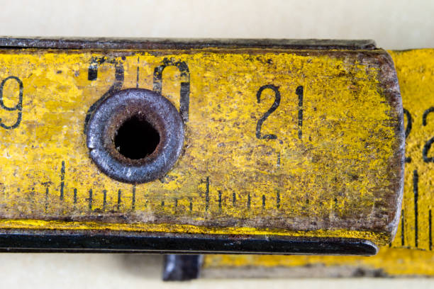 istock Old measure carpentry on a wooden workshop table. Joinery accessories shown in a large magnification. Light background. 931130252