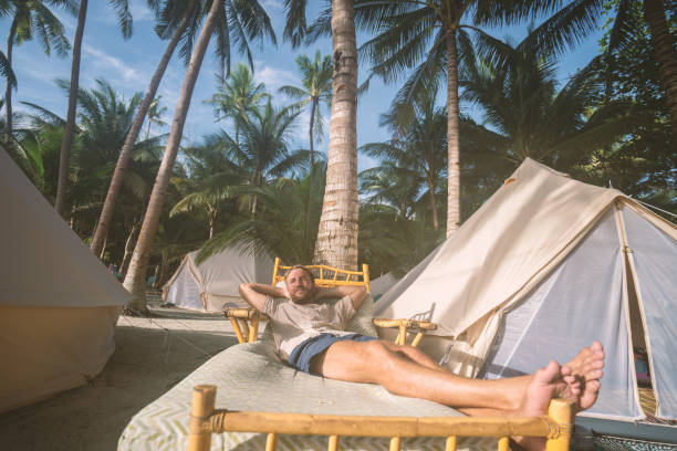 istock Young man relaxing in luxury campsite 931131232
