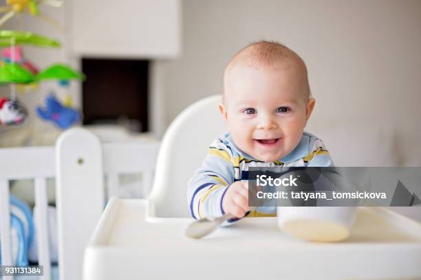 Cute Little Baby Boy Eating Mashed Vegetables For Lunch Mom Feeding Him Stock Photo - Download Image Now