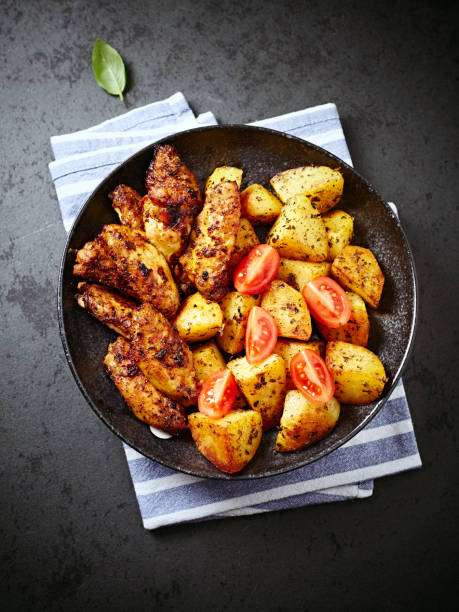 istock Roasted chicken with baked potatoes on a plate 931134206