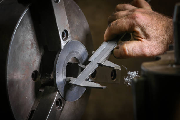 istock Worker professionally measuring the shaped material on lathe 931135960