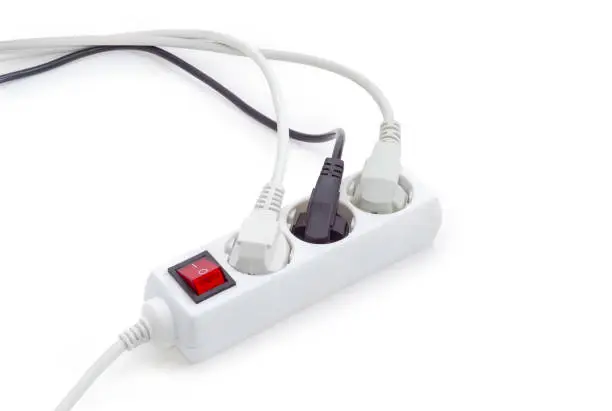 Photo of Power strip with three connected power plugs with corresponding cables