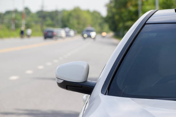 istock close up front of white car on the road 931145450