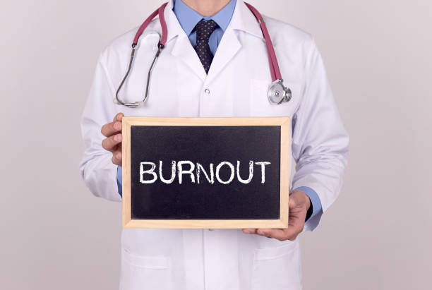 istock Doctor holding mini blackboard with BURNOUT message 931159122