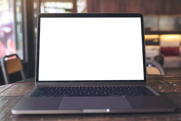 istock Mockup image of laptop with blank white desktop screen on wooden table 931160934