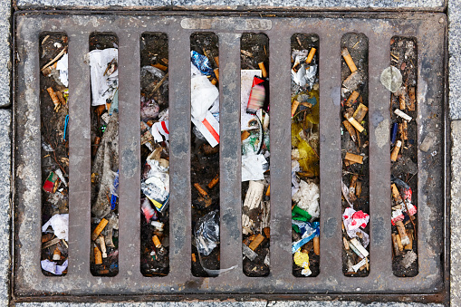 Sewer full of garbage. Urban pollution. Waste treatment. Clean cities