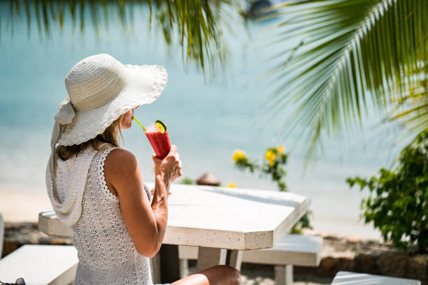 istock Woman with sun hat drinking fresh cocktail during her summer vacation. 931168174