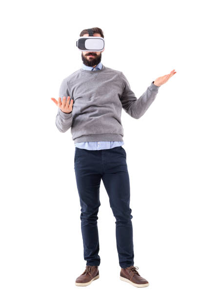 istock Confused man wearing vr glasses with raised hands and open palms standing 931169232